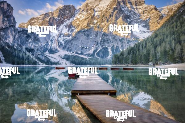 Lago di Braies and row boats at sunrise in the Dolomites