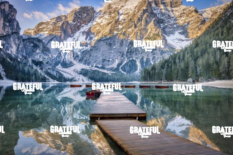 Lago di Braies and row boats at sunrise in the Dolomites