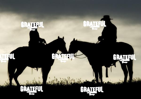 cowboy and cowgirl on horseback