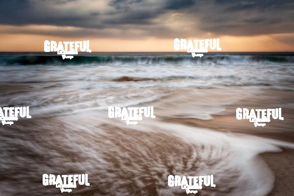 Sunset and waves crashing off the coast of Burma