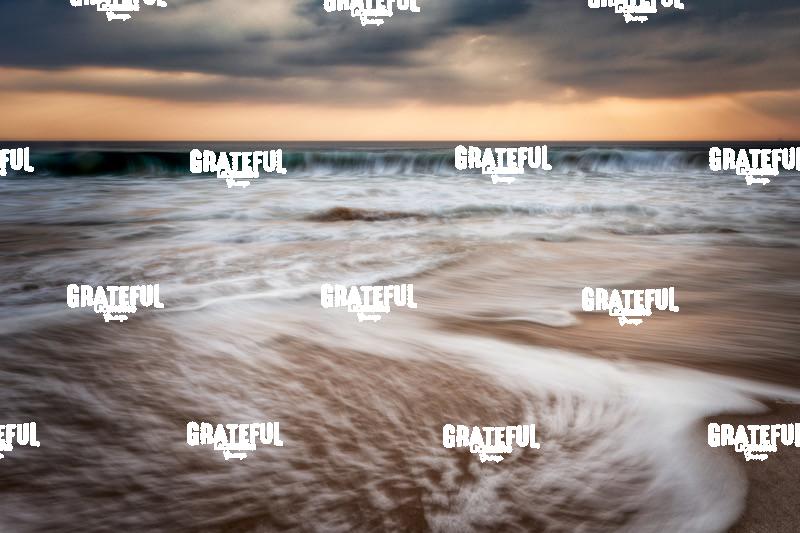 Sunset and waves crashing off the coast of Burma
