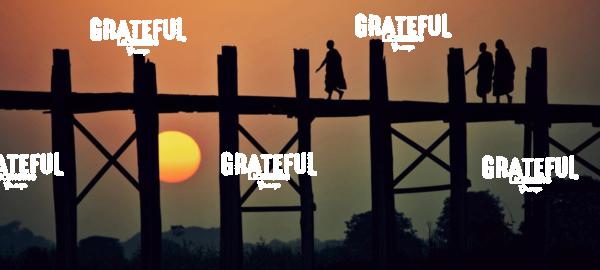 Monks walking across the Ubein Bridge in Burma at sunset
