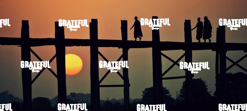 Monks walking across the Ubein Bridge in Burma at sunset