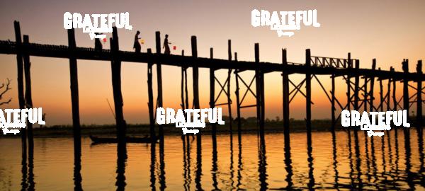 Women with lanterns walking across the Ubein Bridge in Burma