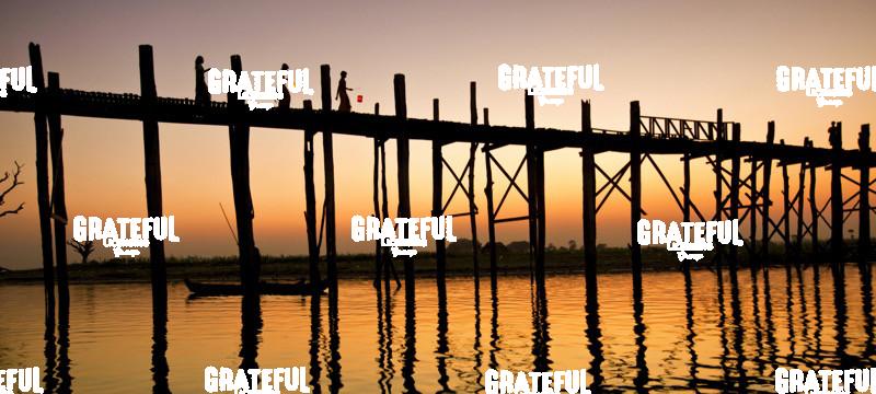 Women with lanterns walking across the Ubein Bridge in Burma