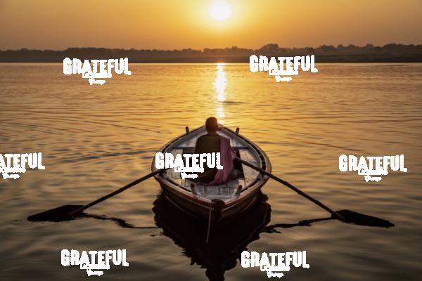 Man Rowing a longtail boat on the Ganges River, Varinasi, India