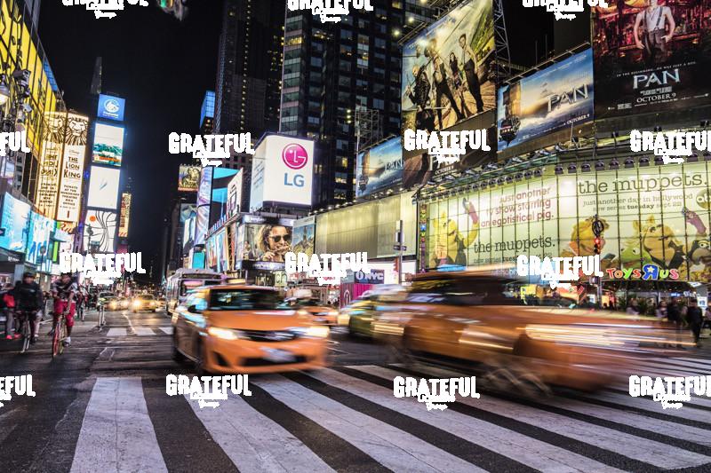 Neon signs and traffic in Times Square at night, New York