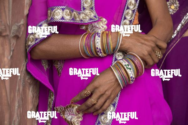 Jewelry on woman's arms by the Taj Mahal in India