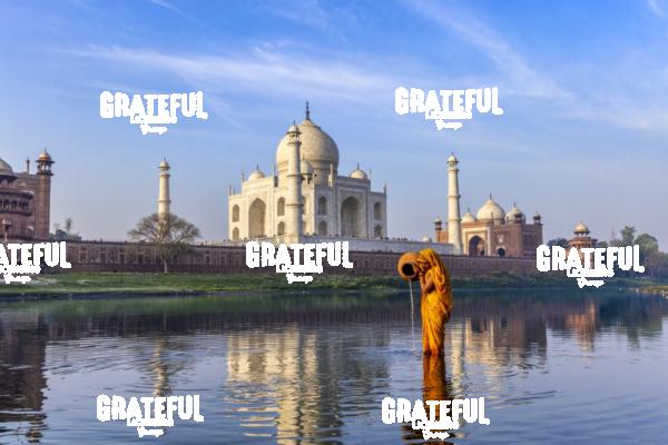Woman gathering water behind the Taj Mahal