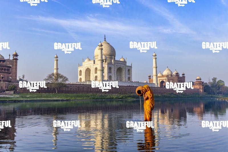 Woman gathering water behind the Taj Mahal