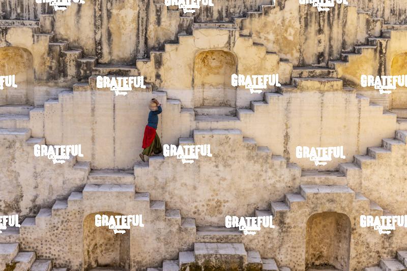 woman carrying jug of water stepwell jaipur India