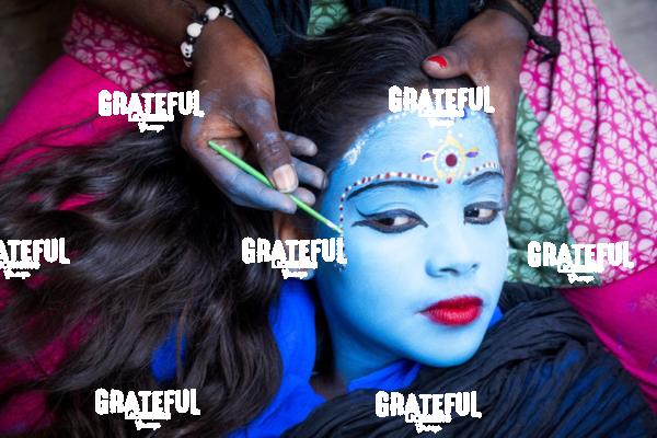 Young girl having her face painted in Varinasi, India 2